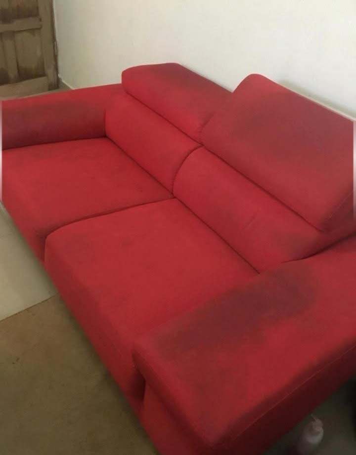 Red sofa before cleaning